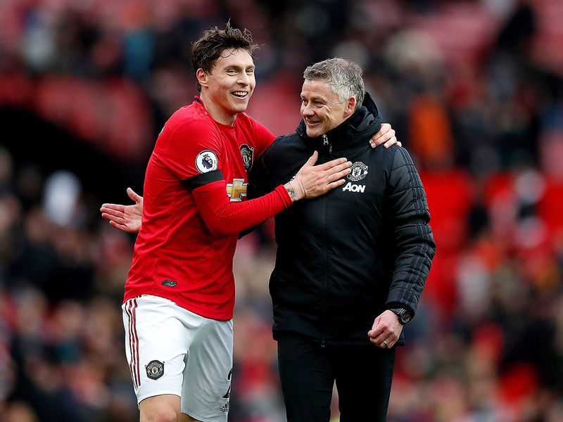 Manchester United's Victor Lindelof, left, and manager Ole Gunnar Solskjaer after the final whistle during the English Premier League soccer match against Watford at Old Trafford, Manchester, England, Sunday Feb. 23, 2020. (Martin Rickett/PA via AP)