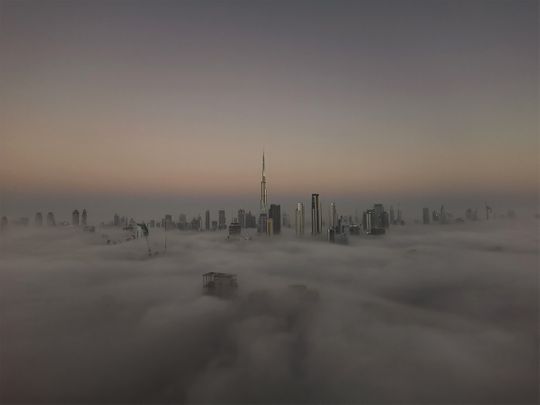 A view of the fog-covered Dubai skyline with Burj Khalifa in the background, from Damac Towers by Paramount Hotels