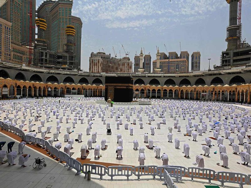 Muslim worshipers pray around the Kaaba, the holiest shrine in the Grand mosque complex in the Saudi city of Mecca, during the Friday prayers of Ramadan, on April 16, 2021. 