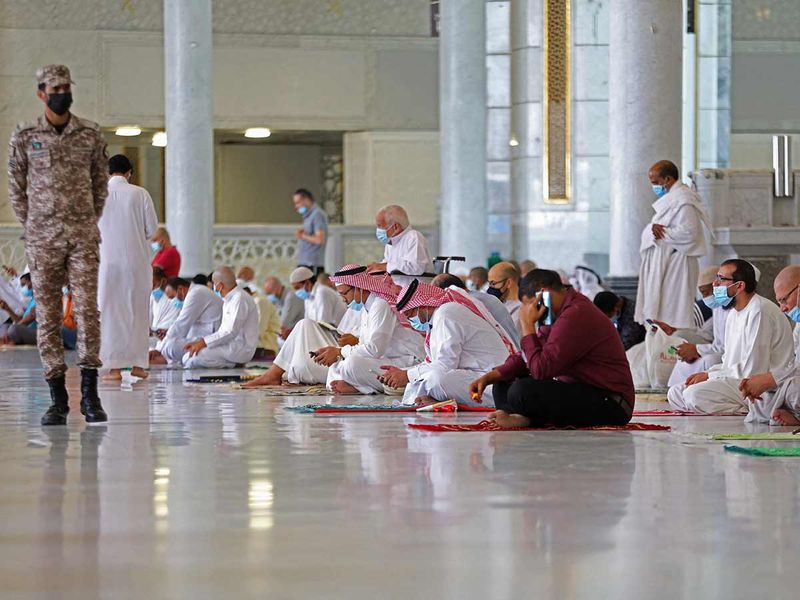 Worshippers pray inside the Grand Mosque in the Saudi holy city of Mecca, during the first Friday prayers of Ramadan, on April 16, 2021. 