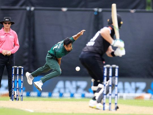 Bangladesh's Tanzim Hasan Sakib (L) bowls to New Zealand's Josh Clarkso