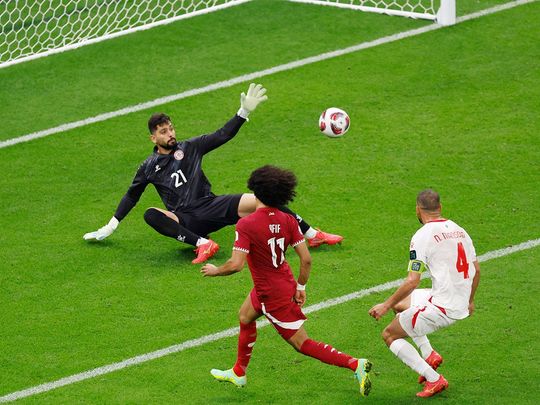 Qatar's forward #11 Akram Afif scores his team's third goal 