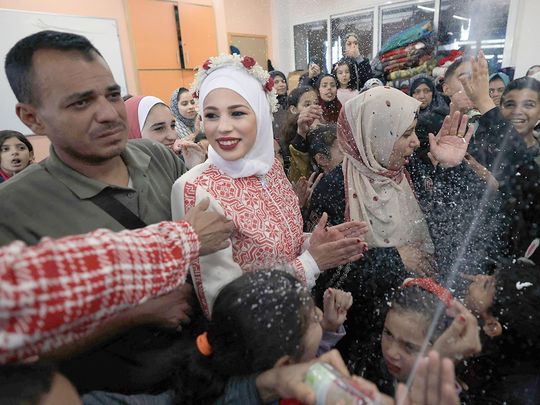 Palestinian newly-wed couple Afnan Jibril (2nd left) and Mostafa Shamlakh