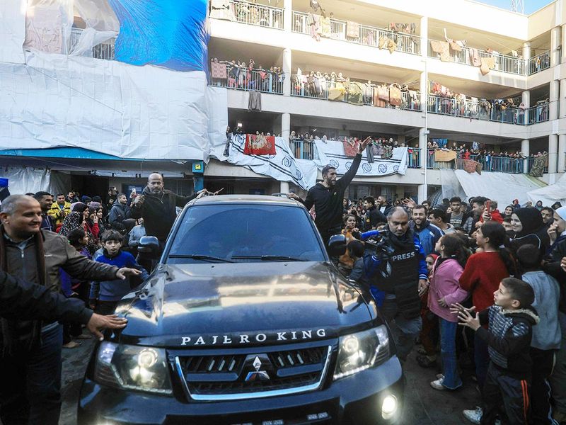 Palestinian newly-wed couple Afnan Jibril and Mostafa Shamlakh leave in a car 