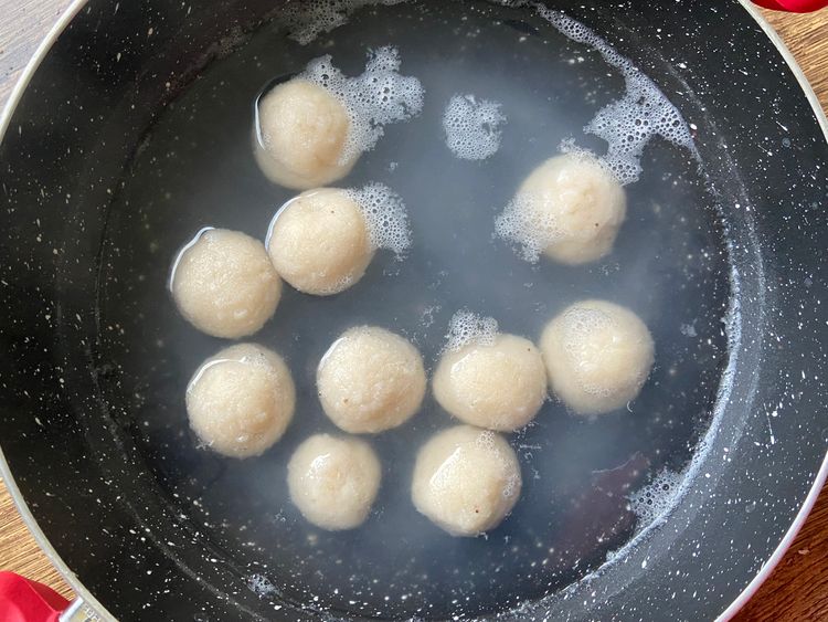 Once the water starts to boil, drop in the dough balls.