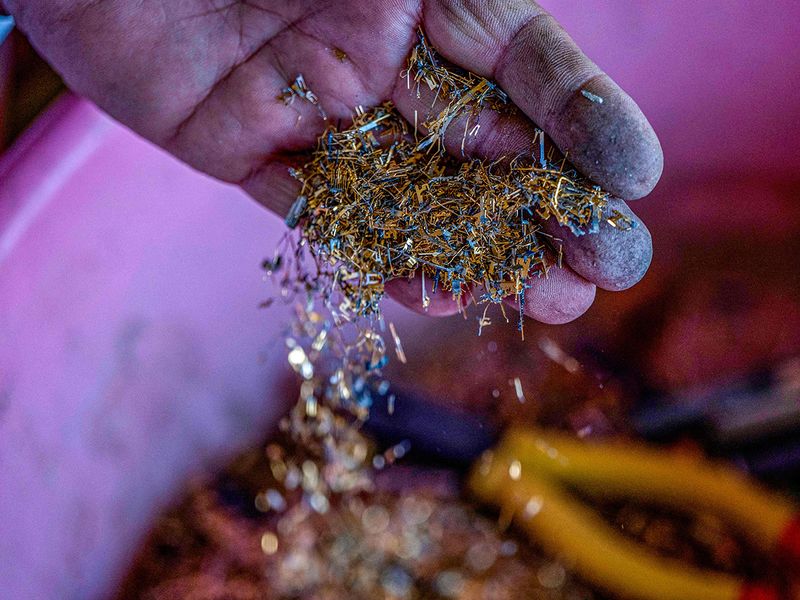 An Afghan smelter extracts gold from cameras and car navigation screen